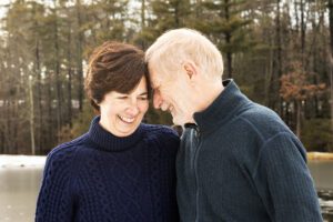 A candid moment of love and connection between a husband and wife during their family session in Stow, Massachusetts