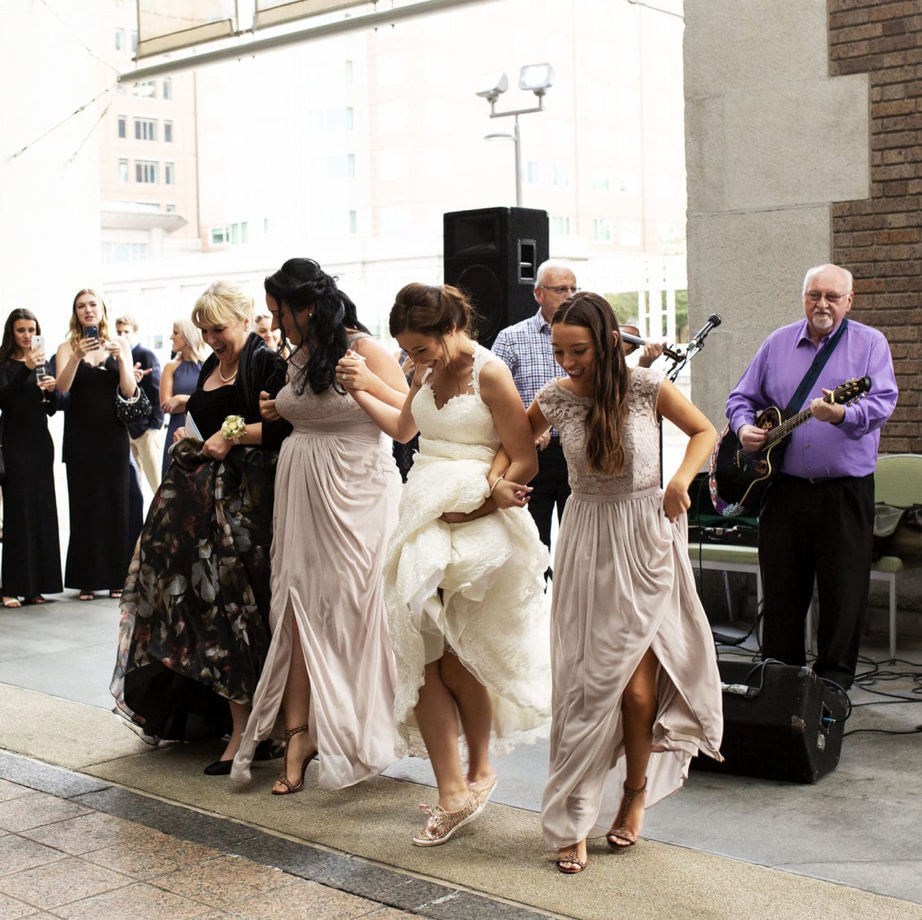 A bride dances with her mother and sisters to Irish music at a wedding in downtown Boston